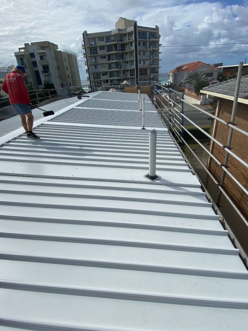 Roofer Cleaning Roof With Brush — Ryan Roofing Australia In Court Carrara, QLD